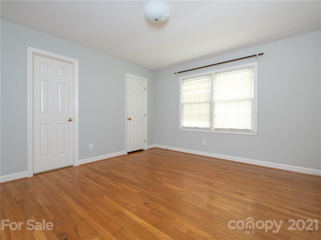 925 Reverdy Lane Matthews, NC 28105 - Photo 25 of 36 a view of an empty room with wooden floor and a window