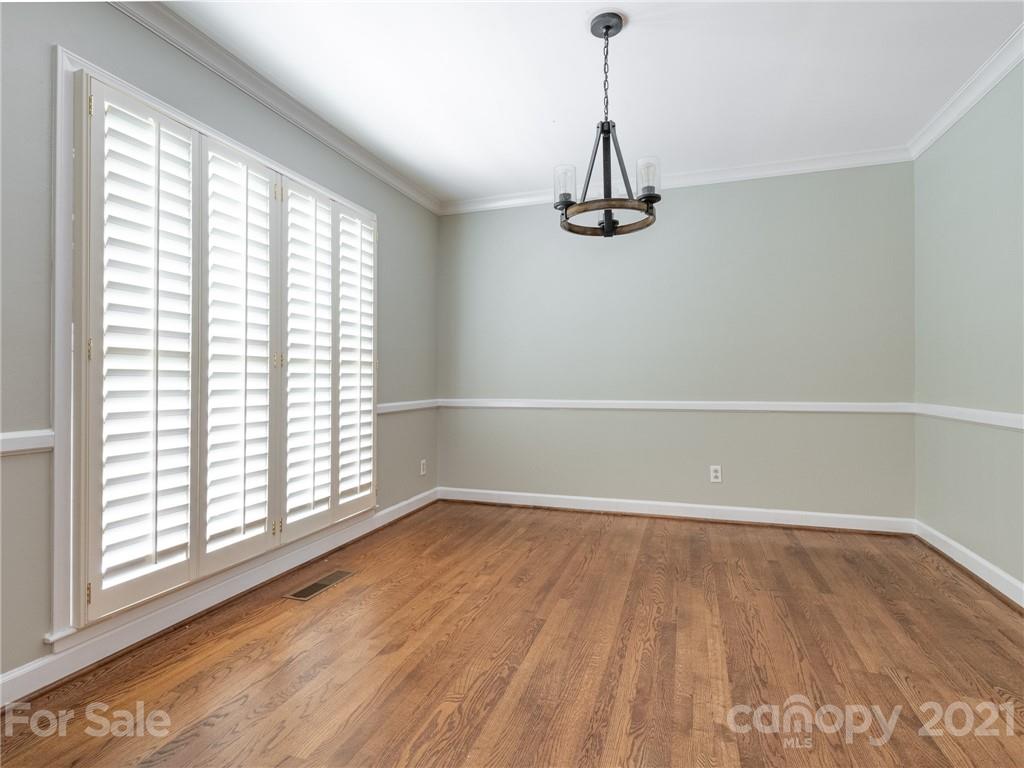 925 Reverdy Lane Matthews, NC 28105 - Photo 4 of 36 a view of an empty room with wooden floor and a window