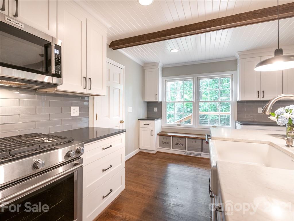 925 Reverdy Lane Matthews, NC 28105 - Photo 7 of 36 a kitchen with stainless steel appliances granite countertop a stove and a white cabinets