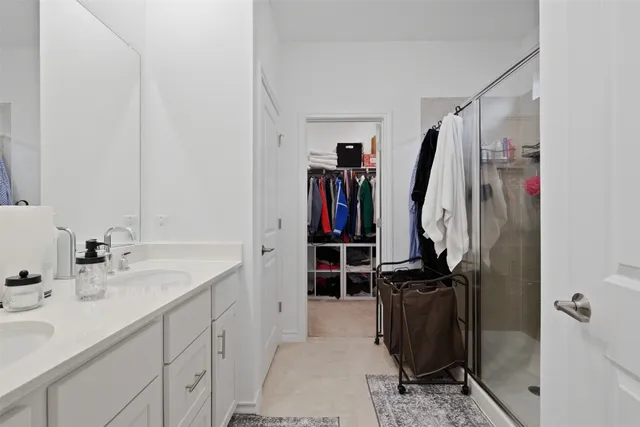 a view of walk in closet with clothes