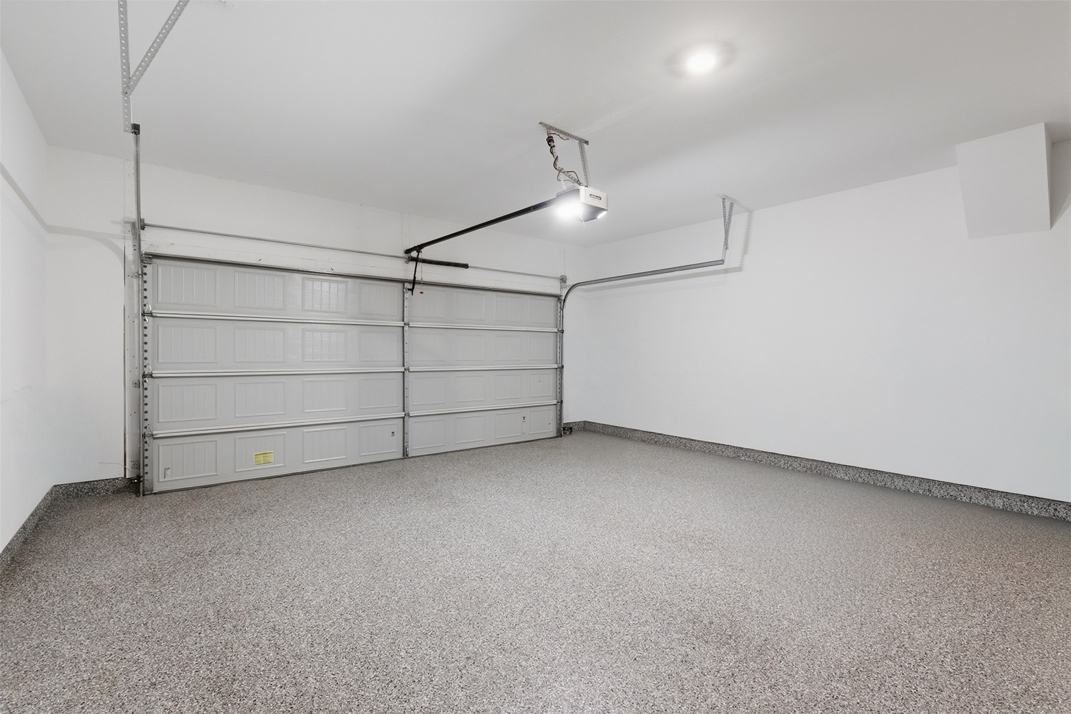 203 Stinchcomb Road Hutto, TX 78634 - Photo 20 of 30 Garage with baseboards and a garage door opener