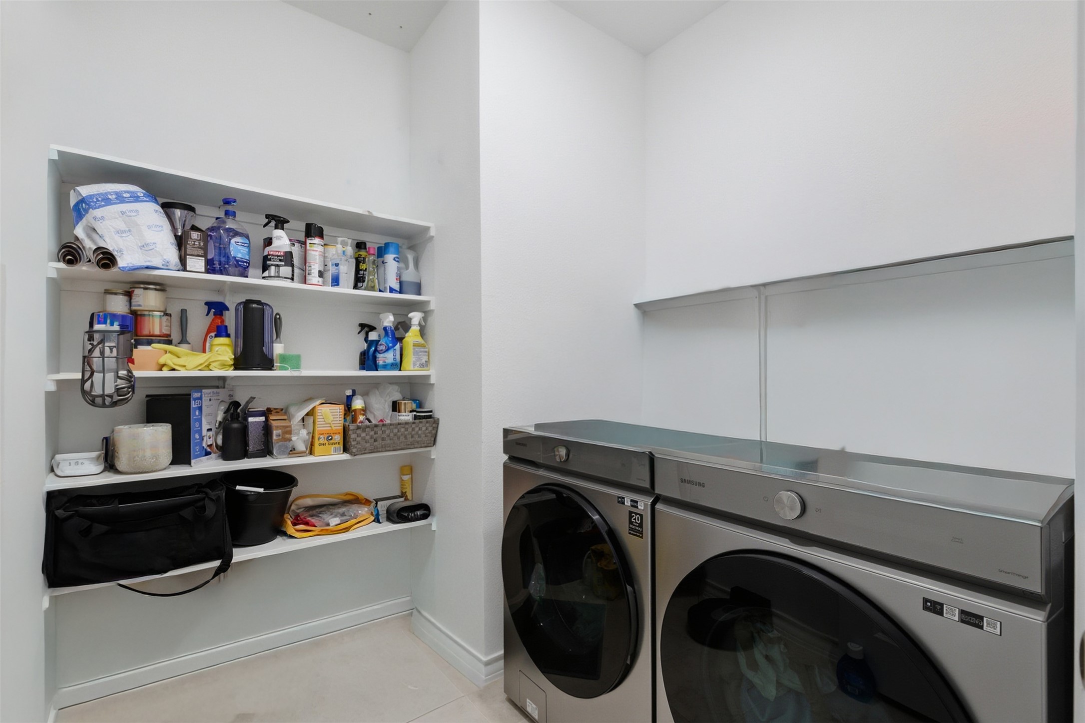 203 Stinchcomb Road Hutto, TX 78634 - Photo 24 of 30 Laundry area featuring washing machine and dryer and light tile patterned flooring