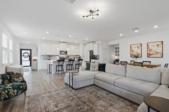 a living room with furniture and wooden floor