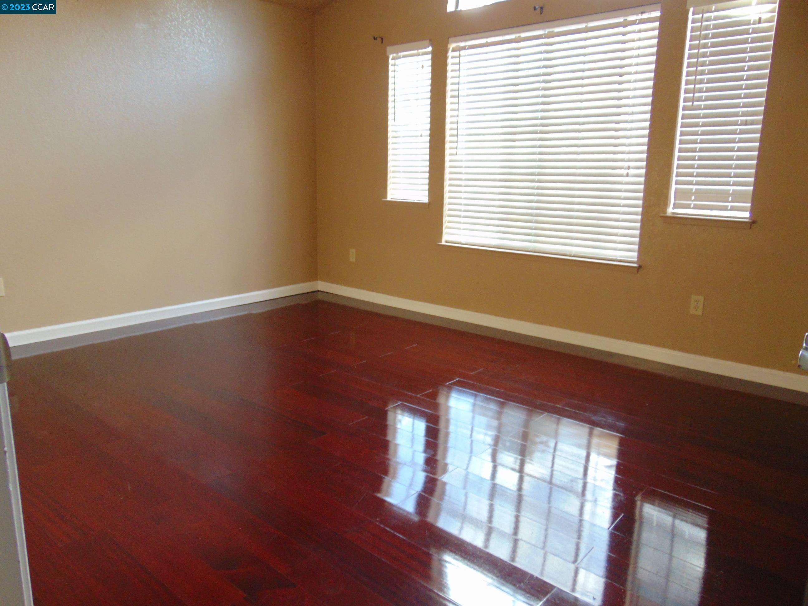 904 Devonwood Hercules, CA 94547 - Photo 12 of 18 a view of an empty room with wooden floor and a window