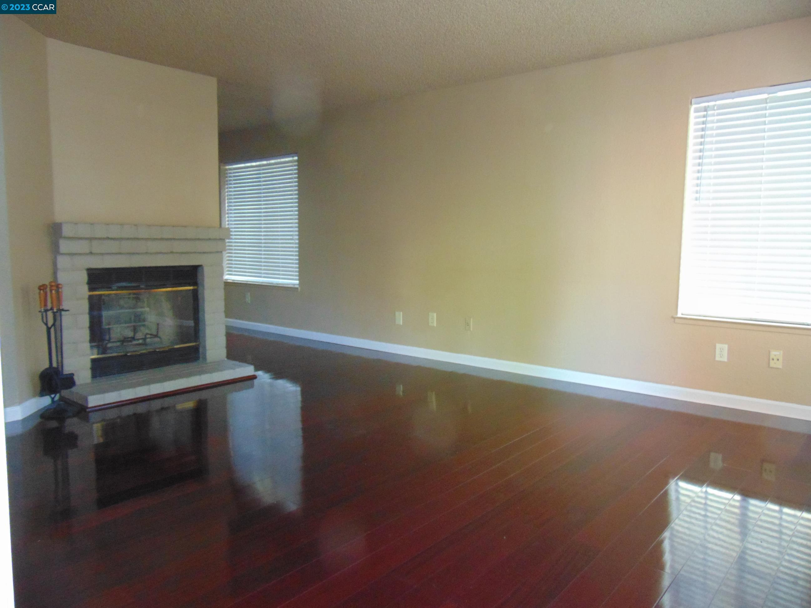 904 Devonwood Hercules, CA 94547 - Photo 3 of 18 a view of empty room with wooden floor and fireplace