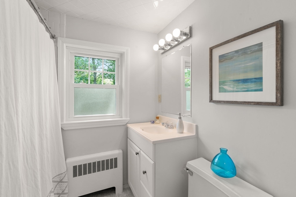 19 Conant Road Brookline, MA 02467 - Photo 11 of 18 a bathroom with a sink a vanity and a window