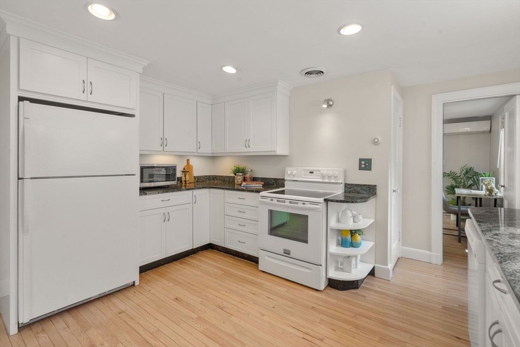 19 Conant Road Brookline, MA 02467 - Photo 5 of 18 a kitchen with granite countertop a refrigerator and a stove top oven