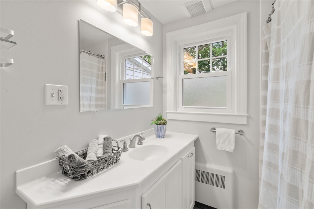 19 Conant Road Brookline, MA 02467 - Photo 9 of 18 a bathroom with a sink vanity and mirror