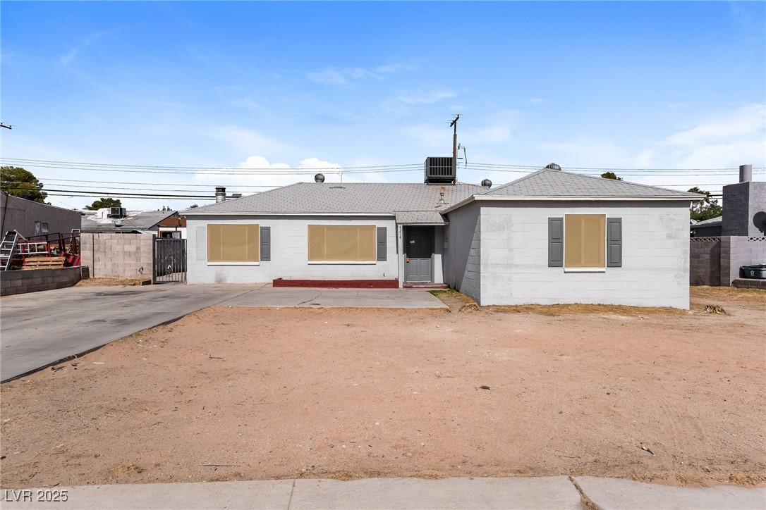 Ranch-style home with central AC unit, concrete bl