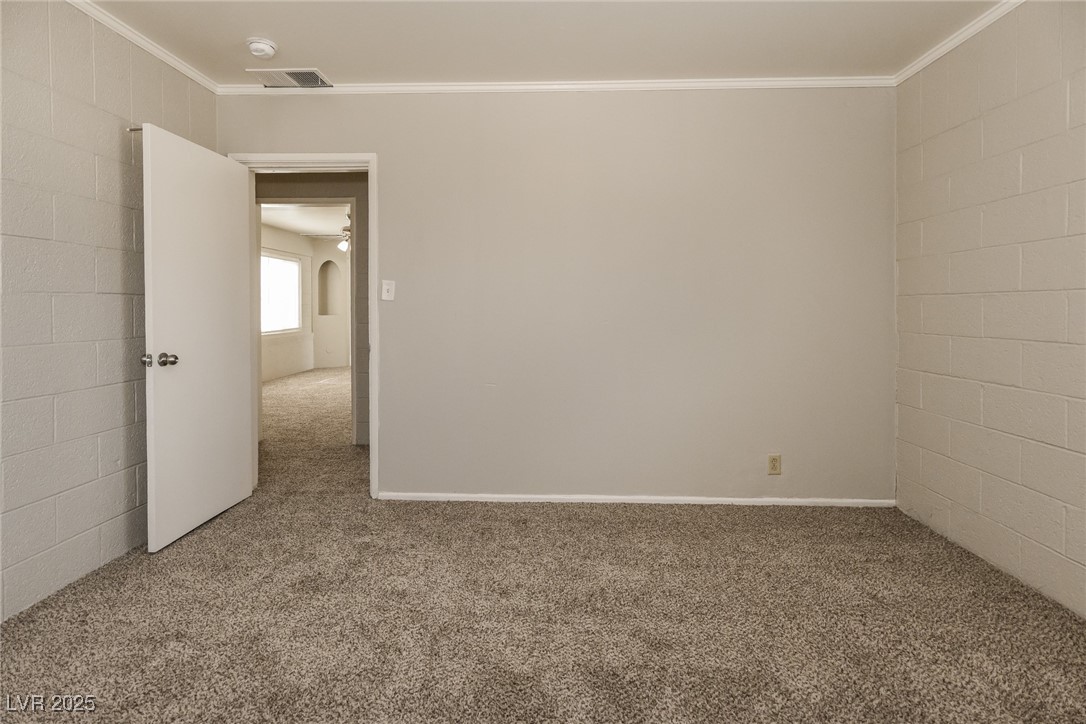 Undisclosed Address Las Vegas, NV 89107 - Photo 12 of 15 Carpeted empty room featuring crown molding and vi