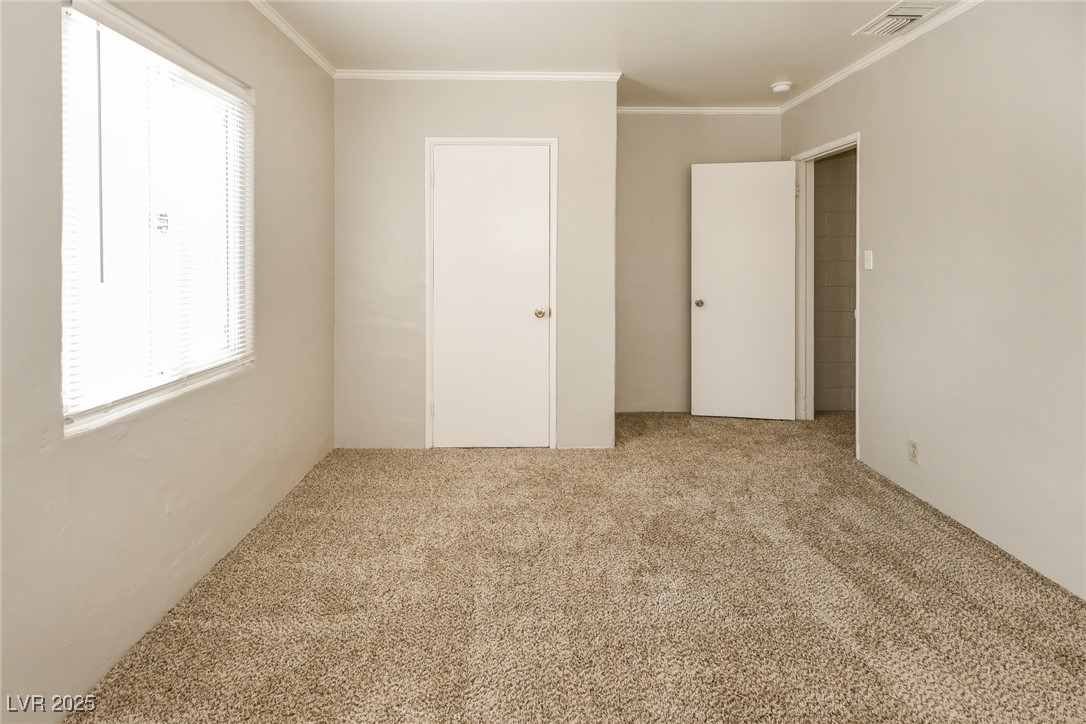 Undisclosed Address Las Vegas, NV 89107 - Photo 10 of 15 Unfurnished bedroom with visible vents, crown mold