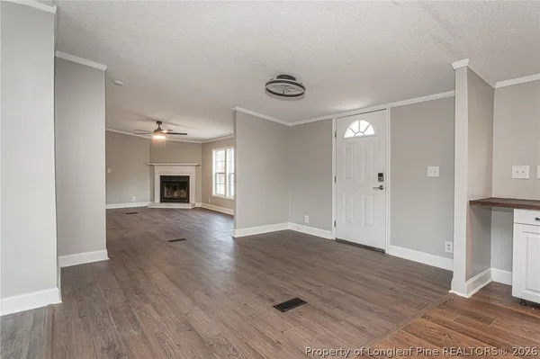 a view of empty room with wooden floor