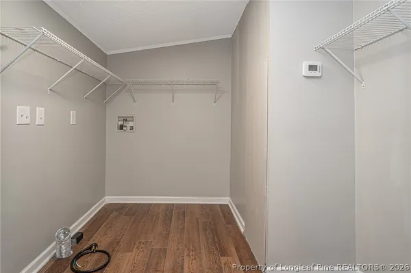 a view of a room with wooden floor