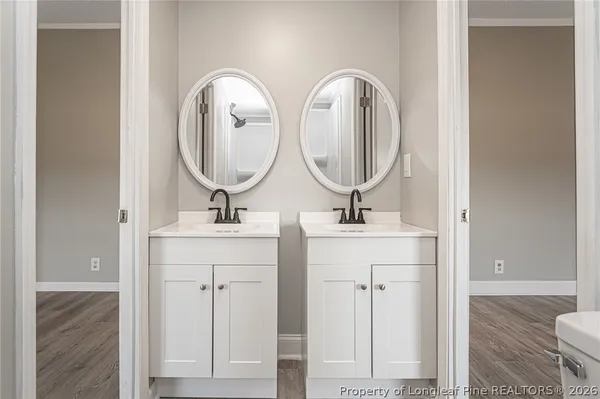 a bathroom with a double vanity sink and a mirror