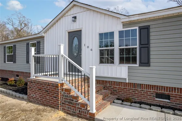 a view of a house with a small deck