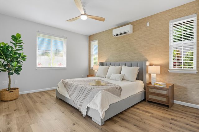 a bedroom with bed and a potted plant