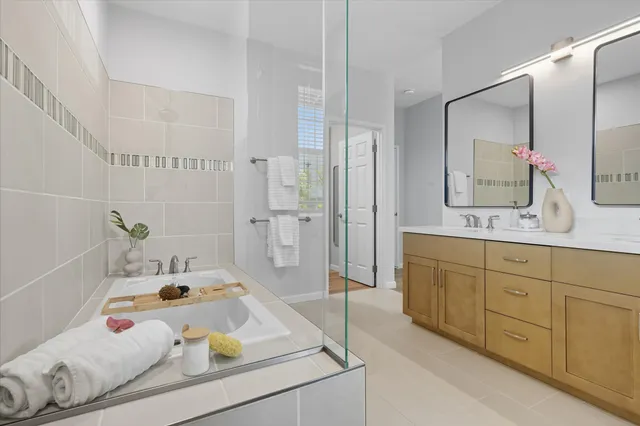 a bathroom with a tub sink and mirror