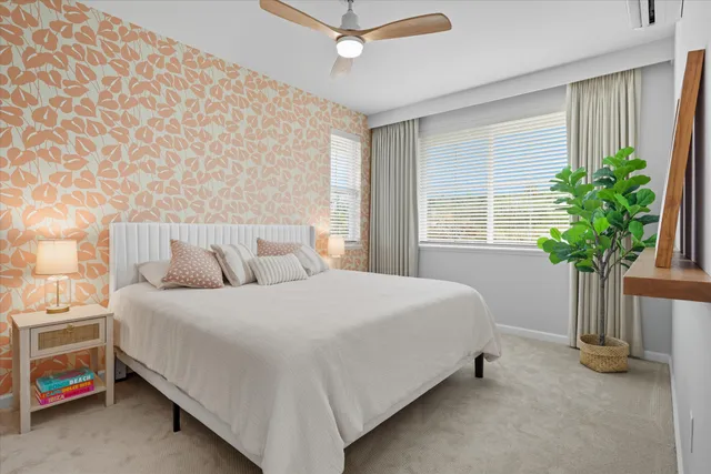 a bedroom with a bed and a potted plant