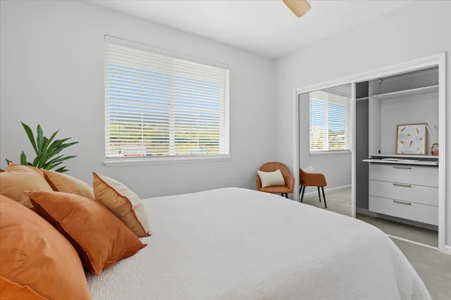 a bedroom with a bed and a closet