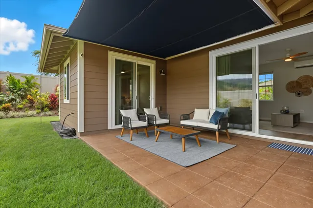 a backyard of a house with outdoor seating
