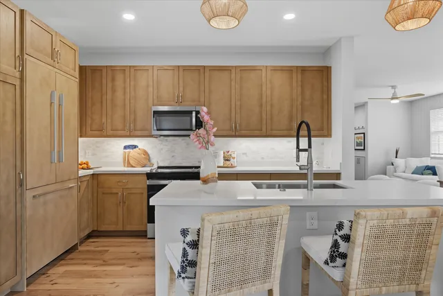 a kitchen with stainless steel appliances granite countertop a sink stove and refrigerator
