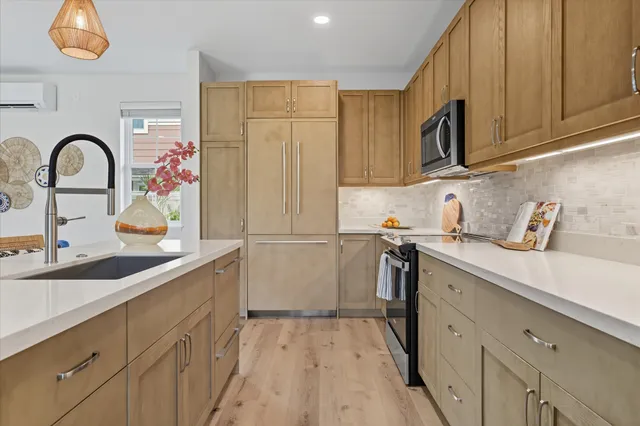 a kitchen with stainless steel appliances granite countertop a sink and a microwave
