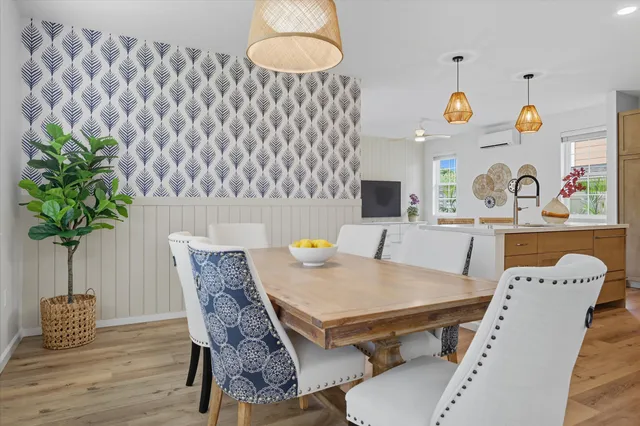 a dining room with furniture and wooden floor