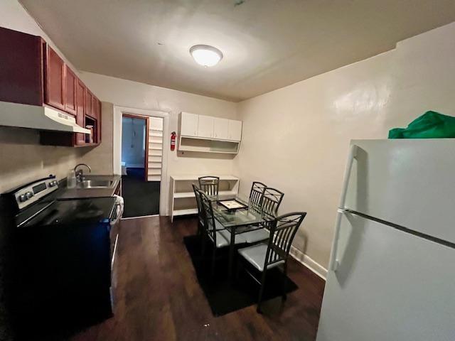 541 Kings Highway Brooklyn, NY 11223 - Photo 3 of 10 a kitchen with stainless steel appliances granite countertop a refrigerator a stove a sink dishwasher and a microwave with wooden floor