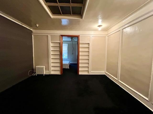 541 Kings Highway Brooklyn, NY 11223 - Photo 5 of 10 an empty room with wooden floor and windows