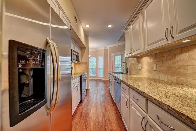 a view of a kitchen with a sink and wooden floor