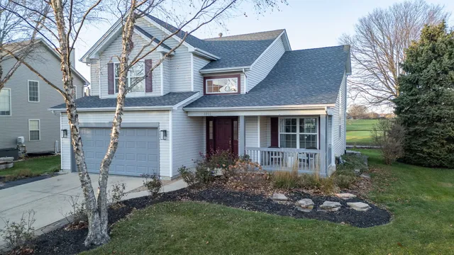 a front view of a house with a garden and plants
