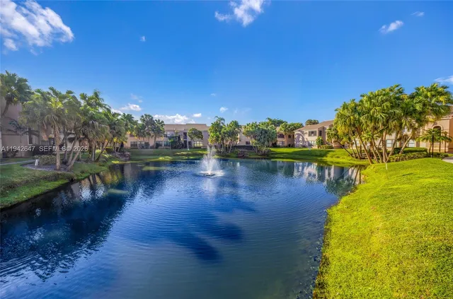 a view of a lake with houses in the background