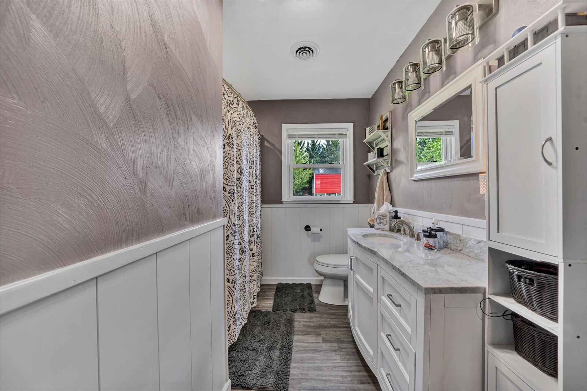 6203 Roberta Road Roanoke, VA 24019 - Photo 12 of 28 a bathroom with a double vanity sink mirror and toilet