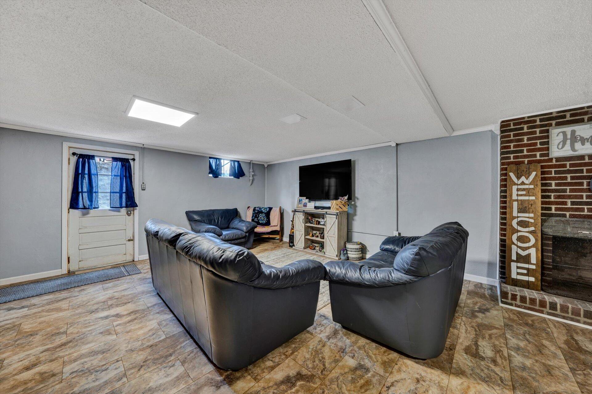 6203 Roberta Road Roanoke, VA 24019 - Photo 18 of 28 a living room with furniture and a flat screen tv