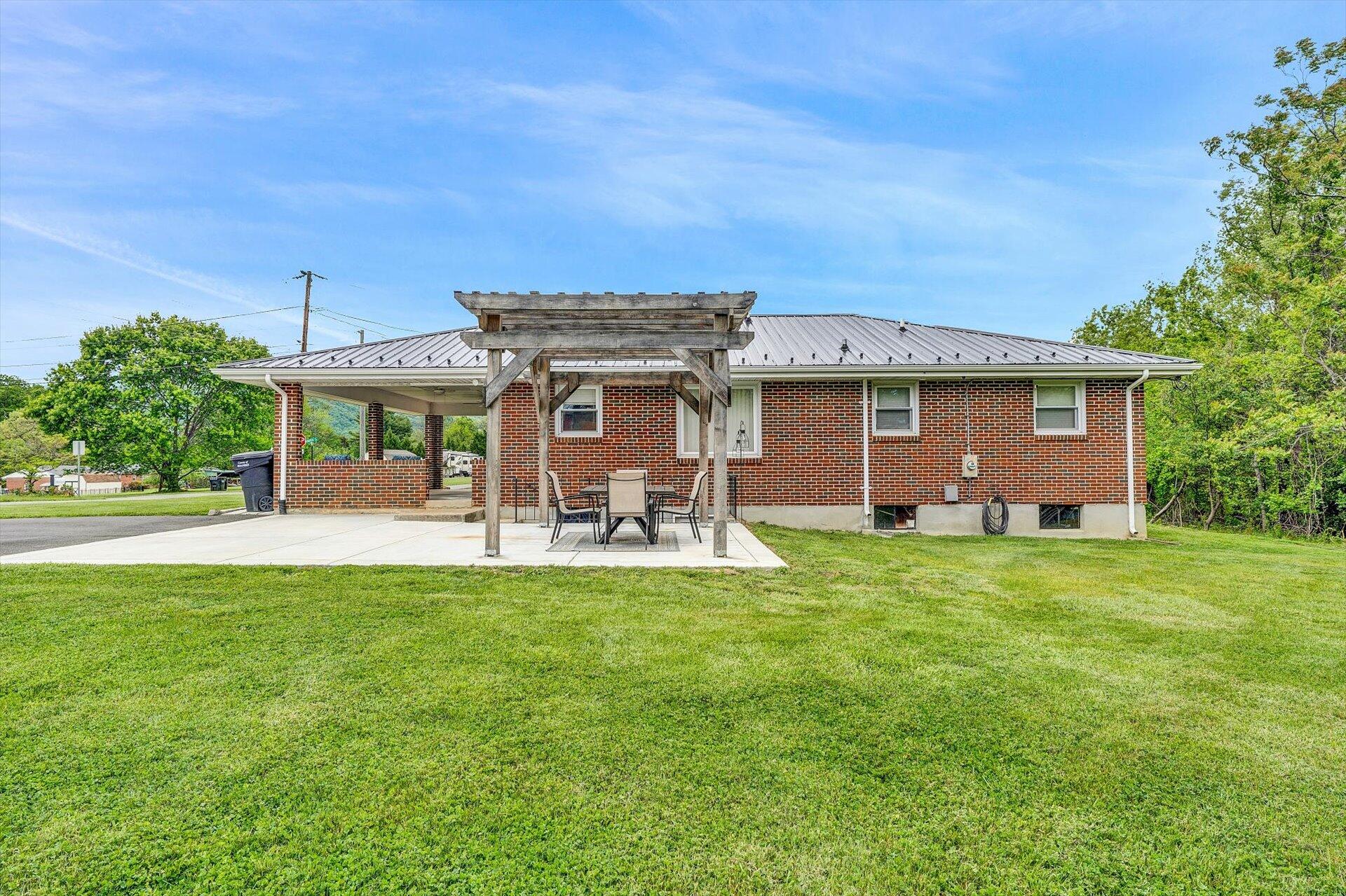 6203 Roberta Road Roanoke, VA 24019 - Photo 22 of 28 a view of a house with backyard porch and garden