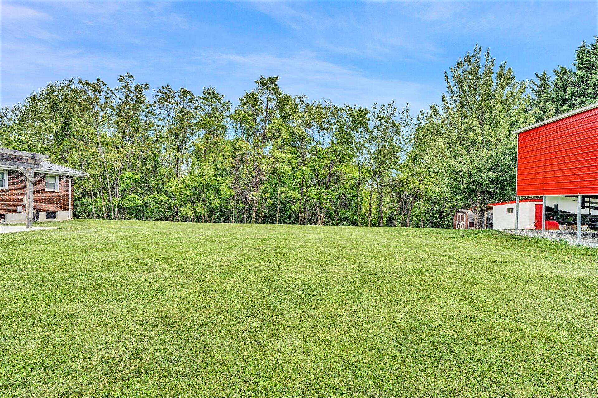 6203 Roberta Road Roanoke, VA 24019 - Photo 26 of 28 a backyard of a house with lots of green space and outdoor space