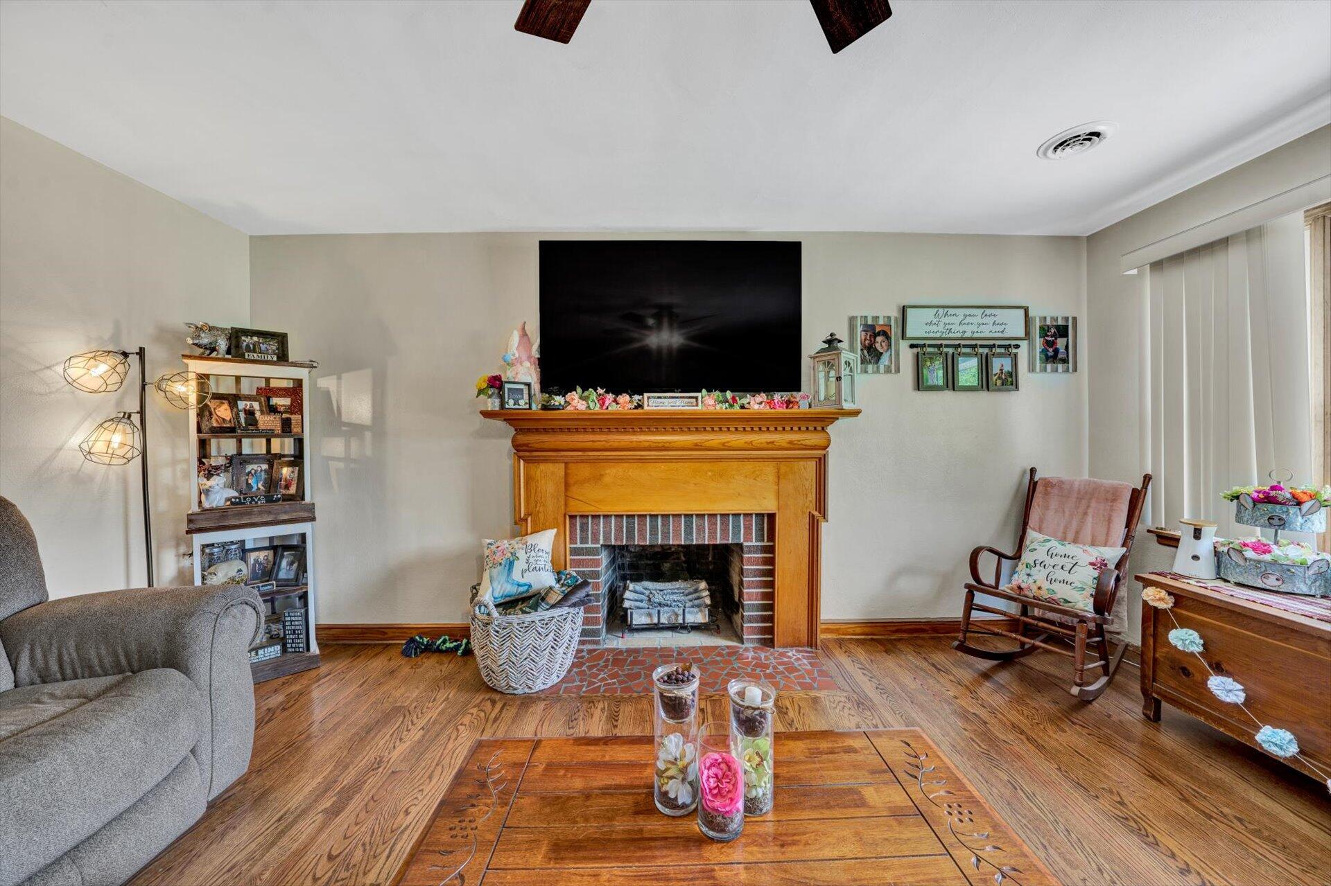 6203 Roberta Road Roanoke, VA 24019 - Photo 6 of 28 a living room with furniture a flat screen tv and a fireplace