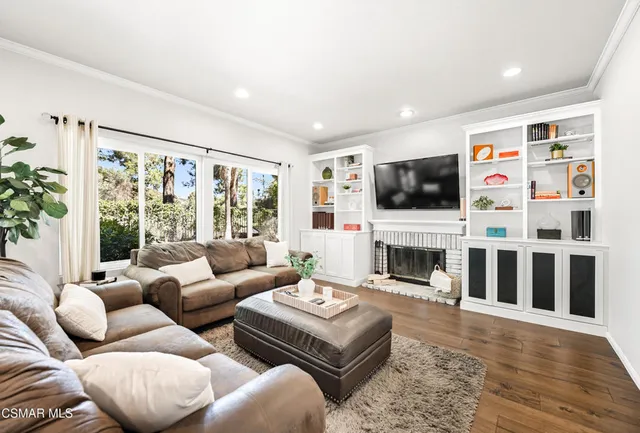 a living room with furniture fireplace and flat screen tv