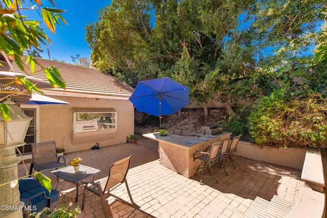 a view of a chairs and table in backyard
