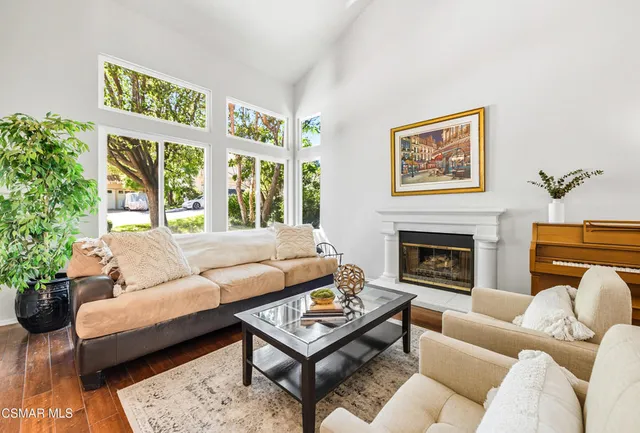 a living room with furniture a flat screen tv and a fireplace