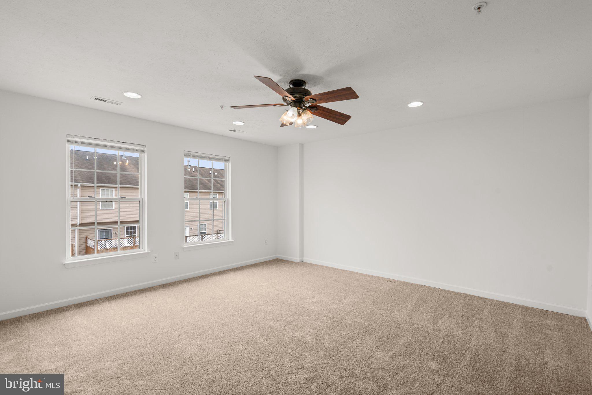 887 Middle River Road Middle River, MD 21220 - Photo 25 of 42 an empty room with windows and fan