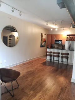 a kitchen with stainless steel appliances granite countertop a refrigerator a stove a sink and a refrigerator