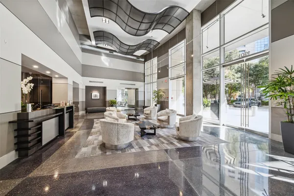 a living room with lots of furniture and a large window