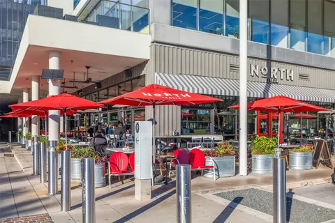 a view of a house with a yard and table and chairs