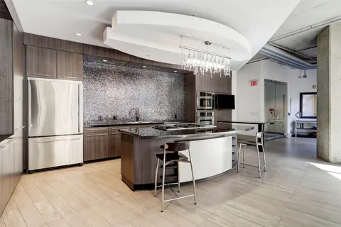 a kitchen with a sink stainless steel appliances and cabinets