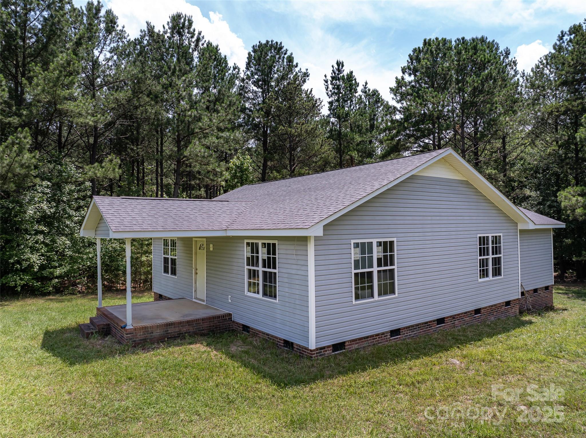 5410 A R Gordon Road Waxhaw, NC 28173 - Photo 21 of 31 a view of a house with a yard potted plants and large tree
