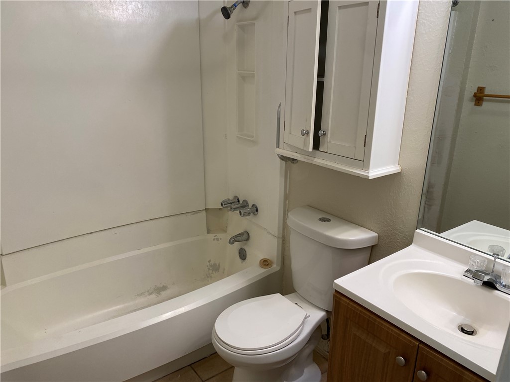 11906 Alpheus Avenue, Unit D Austin, TX 78759 - Photo 9 of 10 a bathroom with a sink toilet and shower