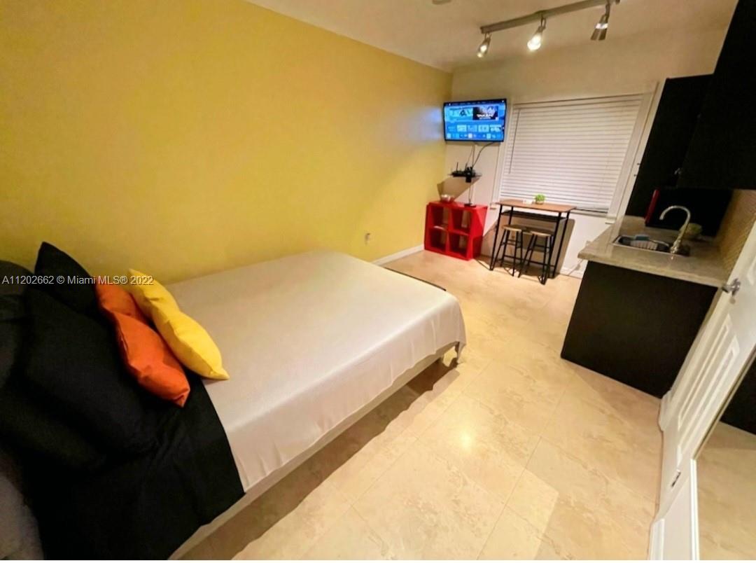 335 Ocean Drive, Unit 237 Miami Beach, FL 33139 - Photo 3 of 16 a bedroom with a bed and dresser