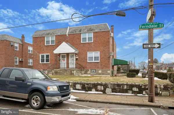 a front view of a house with parking space
