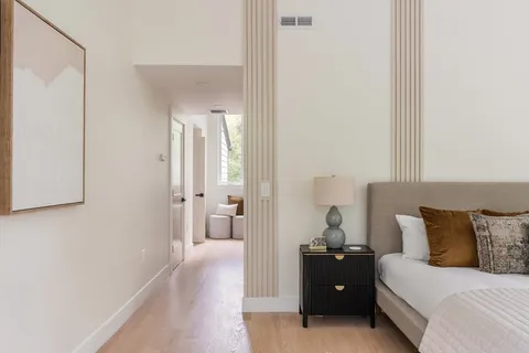 a bedroom with a bed and lamp